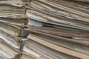 A pile of old documents sitting on top of each other photo