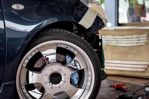 A car with a flat tire and a wheel photo