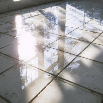 A tile floor with sunlight shining through it photo