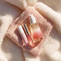 A bottle of perfume, a bottle of lip balm and a bottle of perfume photo