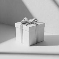 A white gift box with a ribbon on a table photo