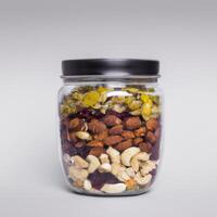 A jar filled xwith nuts and dried fruit photo