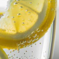 A glass of lemonade with a slice of lemon in it photo
