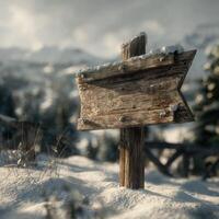 A wooden sign in the snow with mountains in the background photo