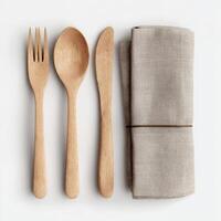 Wooden utensilss and napkin on white background photo