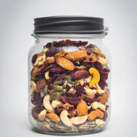 A jar filled with mixed nuts and dried fruit photo