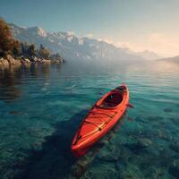 A red kayak floating in the water near mountains photo
