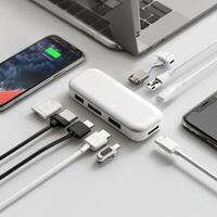 A laptop, phone, and charger are connected xto each other photo