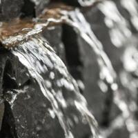 A close up of a waterfall flowing over rocks photo