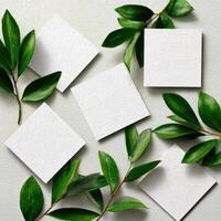 Four blank white cards with green leaves on a white background photo