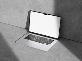 High-angle view of a laptop mockup placed on a textured cement surface, emphasizing simplicity and modernity. photo