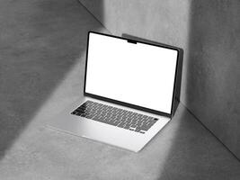 A well-lit laptop mockup on a cement surface, ideal for modern marketing and design projects. photo