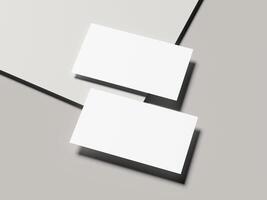 Angled pair of business cards with sharp shadow on light gray background photo