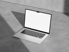 Stylish laptop mockup on a rough cement surface with a minimalist aesthetic, perfect for tech and business designs. photo
