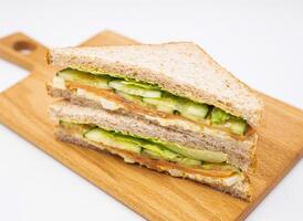ourmet Smoked Salmon, Egg Mayo, Cucumber Whole Wheat Sandwich on wooden board side view of lunch menus photo