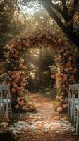 Romantic Floral Archway at a Sunlit Outdoor Wedding Venue Surrounded by Lush Greenery and Vibrant Blooms photo