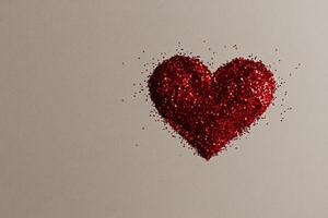 Heart Shaped Glitter Arrangement on a Plain Background for Celebrations and Crafts photo