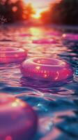 Colorful Inflatable Rings Float on Water at Sunset Reflecting Vibrant Hues photo