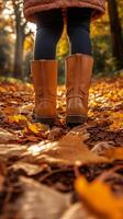 Autumn Walk Through Colorful Leaves Wearing Brown Boots in a Serene Forest photo