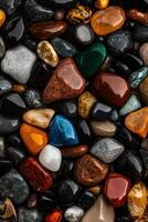 Colorful Collection of Polished Stones From a Riverbed Arranged Naturally on a Dark Surface photo