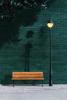 Warm Golden Light Illuminates a Wooden Bench Beside a Green Brick Wall in a Serene Outdoor Setting photo