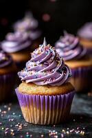 Purple frosted cupcake with sprinkles photo