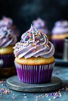 Purple cupcake with colorful sprinkles photo