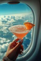 Enjoying a Refreshing Cocktail While Flying High Above the Clouds on a Sunny Day photo