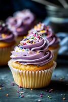 Purple frosted cupcake with sprinkles photo