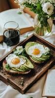 Avocado toast with eggs on wooden tray photo