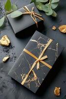 wrapped black and gold gift boxes photo