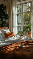 Cozy Morning in a Bright Bedroom With Plants and a Cup of Coffee by the Window photo