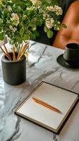 Writing Tools and Fresh Flowers Decorate a Marble Table in a Cozy Indoor Space During the Morning photo