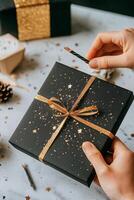 Elegant Black and Gold Gift Boxes Arranged on a Dark Textured Surface With Decorative Elements. photo