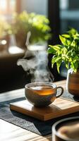 Steaming cup of tea on a table photo