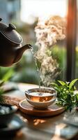Tea pouring into a white cup photo