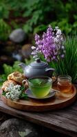 A wooden tray with a tea pot and some flowers photo