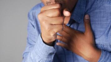 Man coughs while holding chest and showing discomfort video