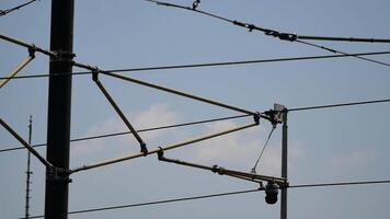 Train power lines over city tracks in bright sky video