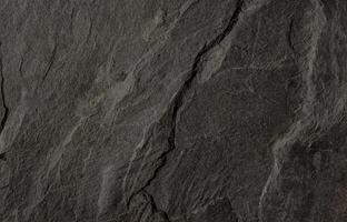Natural dark slate stone texture with rough, layered surface ideal for backgrounds or design use photo
