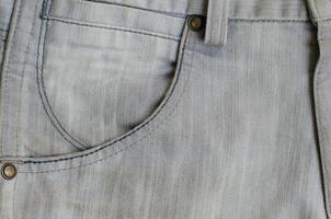 Texture of Gray Denim Jeans with Part of Trousers photo