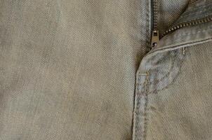 Texture of Brown Denim Jeans with Part of Trousers photo
