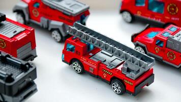 Playing with Toy Fire Trucks on a White Surface photo