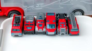 Toy Fire Trucks Collection in a Row on White Surface photo