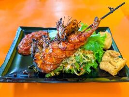 Grilled Prawns Served with Vegetables, Chili Sauce, and Fried Tofu photo