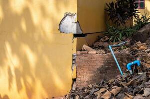 Cropped shot view of cracked building. Wider cracks often represent serious structural damage and can cause serious issues. photo