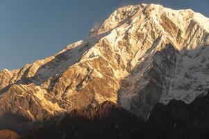 View of Mt.Annapurna South 7,219 m at dawn seen from Mardi Himal view point in the Annapurna region of Nepal. photo