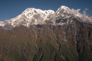 View of Mt.Annapurna South 7,219 m and Mt.Hiunchuli 6,441 m seen from Mardi Himal view point in the Annapurna region of Nepal. photo