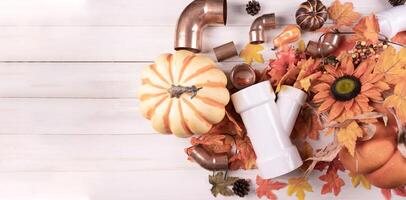 Thanksgiving with construction tools, maple leaves and pumpkin on wood background. Autumn composition with copy space photo