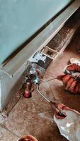 Professional plumber soldering a copper pipe during baseboard heating installation, with copy space for text design elements. photo